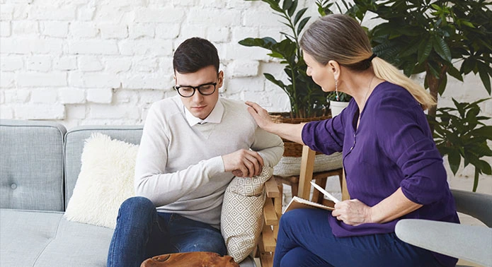 Therapist encouraging a boy during Anxiety therapy session